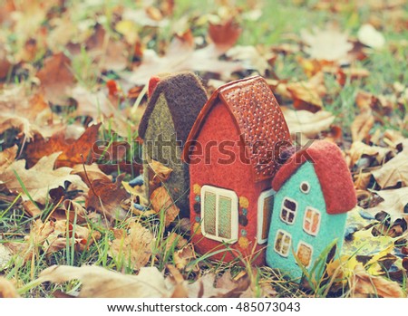 toy houses and autumn leaves

