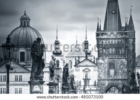View of Charles Bridge and monuments in Prague, Europe. Black&white picture.