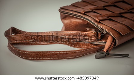Retro styled or retro color minimalist and luxurious brown leather feminine fashion hand bag or sling bag. Slightly de-focused and close-up shot. Copy space.