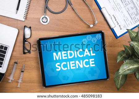 MEDICAL SCIENCE  Professional doctor use computer and medical equipment all around, desktop top view