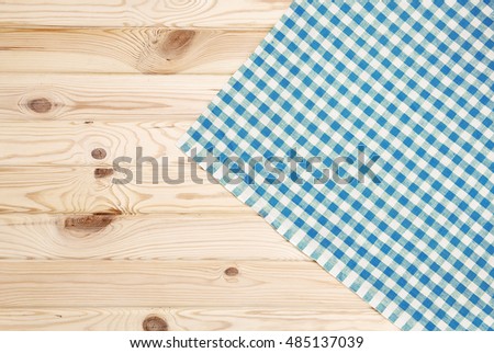 Blue checkered tablecloth on wooden table