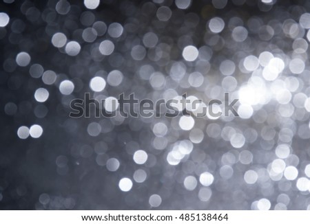 silver Sparkling Lights Festive background with texture. Abstract Christmas twinkled bright  bokeh defocused and Falling stars. Winter . Card or invitation.