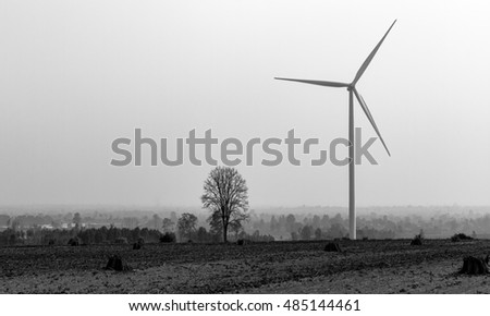 Wind turbines power generator on sky at farmer field - black and white style pictures
