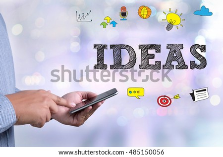 IDEAS person holding a smartphone on blurred cityscape background
