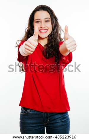 Young positive brunette woman showing thumbs up smiling. Isolated on white