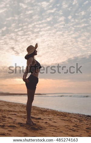 Joyful woman dancing in the sunset on beach background outdoors. Book cover design idea concept