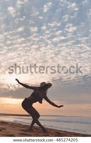Joyful woman dancing in the sunset on beach background outdoors. Book cover design idea concept