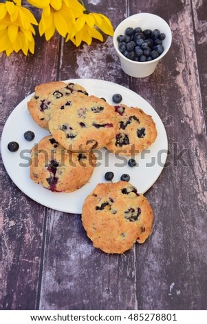 Blueberry cookies on a plate. Dark wooden background
