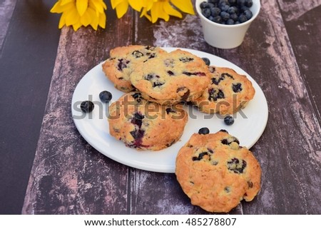 Blueberry cookies on a plate. Dark wooden background