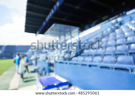 blurry scene of blue sport stadium with chairs