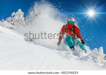 Skier skiing downhill in high mountains Royalty-Free Stock Photo #485296819