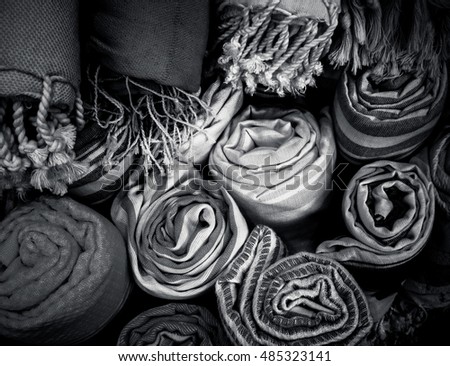 Linen towels and tissue in rolls for your concept of hygiene in retro style. Natural fabrics of flax and cotton close up. Traditional arabic textile as background at black and white colors.