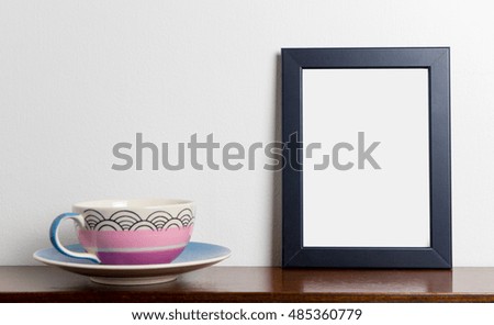 Blank photo frame with pastel tea cup white background