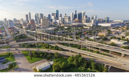 Panorama aerial view downtown and interstate 45, 69 highway intersection, massive intersection, stack interchange and elevated road junction overpass at sunset from the southeast side of Houston, TX.