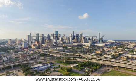Panorama aerial view downtown and interstate 45, 69 highway intersection, massive intersection, stack interchange and elevated road junction overpass at sunset from the southeast side of Houston, TX.