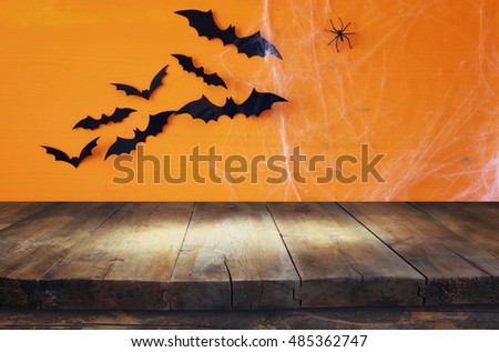 Halloween holiday concept. Empty rustic table in front of spider web background. Ready for product display montage