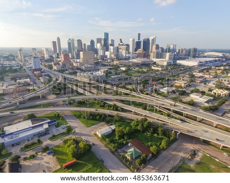 Aerial view downtown and interstate 45 and 69 highway intersection, massive intersection, stack interchange and elevated road junction overpass at sunset from the southeast side of Houston, Texas, USA