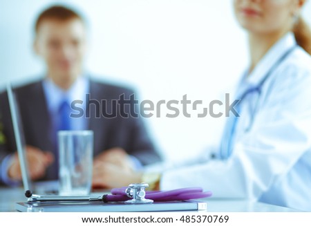 Medical team sitting at the table in modern hospital