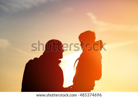 mother and little son travel at sunset