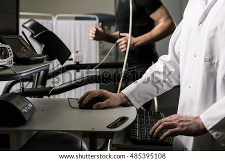 Closeup of a doctor supervising examination of a sportsman on the computer screen 