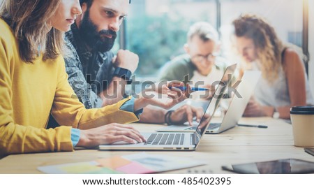 Closeup Group Young Coworkers Together Discussing Creative Project During Work Process.Modern Friends Business Meeting Discussion Startup Concept Loft.Female Hand Showing Laptop Screen.Blurred Flares Royalty-Free Stock Photo #485402395