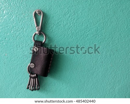 key chain leather on green wall concrete