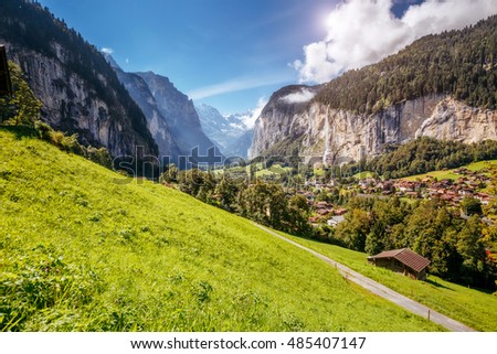 Majestic view of alpine village glowing by sunlight. Picturesque and gorgeous scene. Location famous place Swiss alps, Lauterbrunnen valley, Staubbach waterfall, Europe. Artistic picture. Beauty world