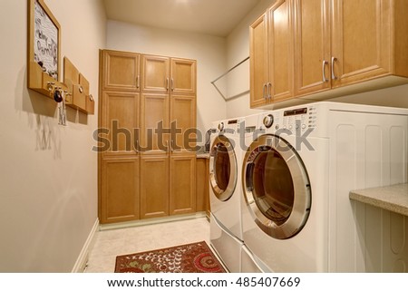 Interior design of laundry room with modern appliances and cabinets. Northwest, USA