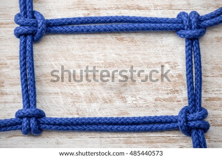 Rope with knots on the background of wooden boards