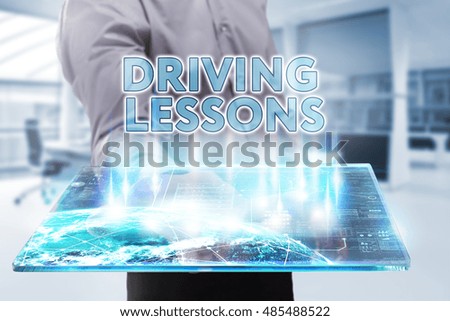 Business, Technology, Internet and network concept. Young businessman working on a tablet of the future, he sees the inscription: driving lessons