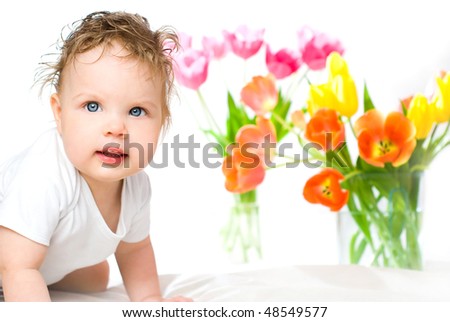 The blue-eyed babe in an environment colour flowers, on a white background