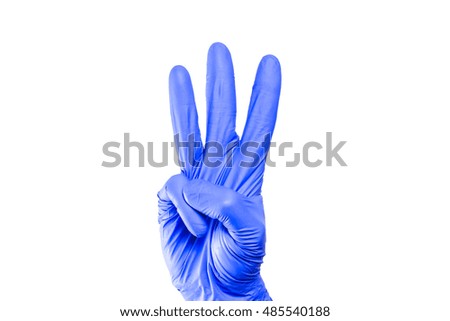 Hand in blue glove isolated on white. Showing number three. Fingers gesture. Latex glove cutout. Symbolic background. Medical sign.