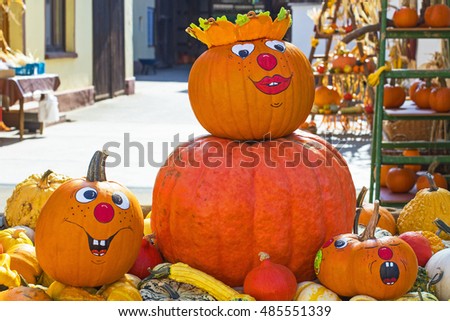 Funny autumn pumpkin face make up. Halloween Pumpkin harvest in autumn. Many different varieties of pumpkins are sold at farmer's market, Germany. 