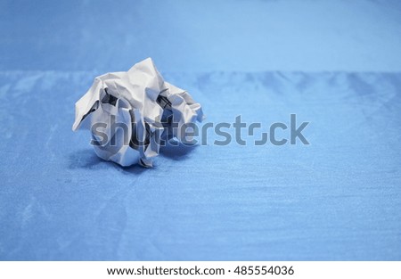 Crumpled paper lump and texture on blue table background in business  meeting  room  with copy space