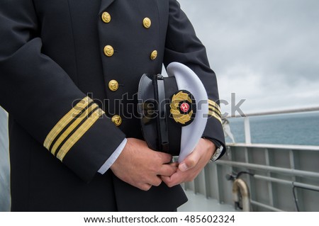 marine sailor holding his hat Royalty-Free Stock Photo #485602324
