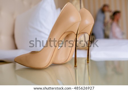 Beige bridal shoes on the high heels