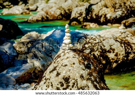 beautiful wild river with turquoise water and stone piles.
