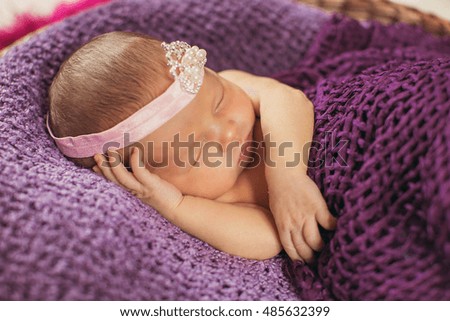 charming  newborn girl  lying in the big basket