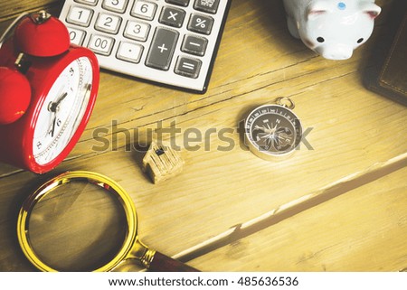 magnifying glass wallet calculator and other objects in the photo wooden