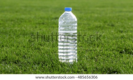 picture of a plastic water bottle on a green grass