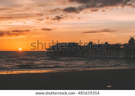 Retro Effect Photo Filter: Blackpool Central Pier, Lancashire, England, UK. Lovely sunset, soft colours, background.