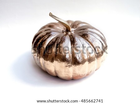 Halloween gold pumpkin painted. Holiday decoration. White background