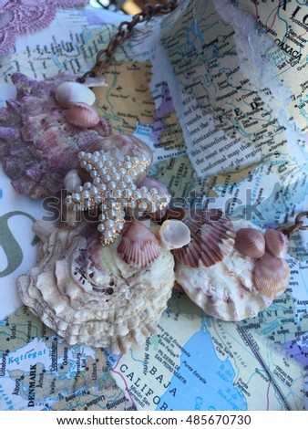 Seashell necklace on maps.
