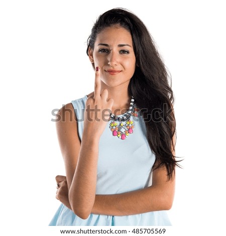 Young cute girl making horn gesture