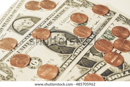 Vintage looking One cent coins and One Dollar banknotes  currency of the United States useful as a background