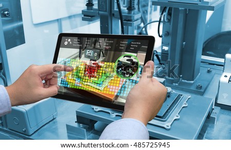 Industry 4.0 concept .Man hand holding tablet with Augmented reality screen software and blue tone of automate wireless Robot arm in smart factory background Royalty-Free Stock Photo #485725945