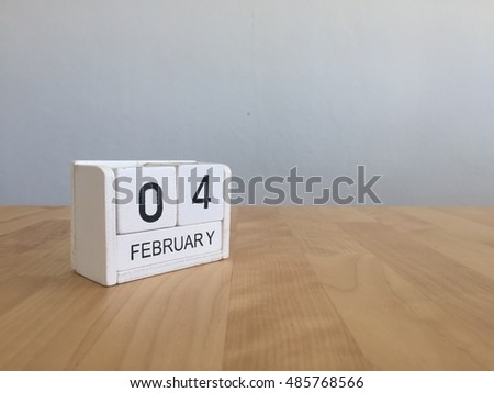 February 4th.February 4 white wooden calendar on vintage wood abstract background.Winter time. Copyspace for your text.