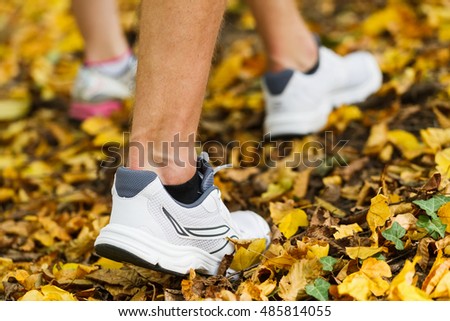 Close up photo of runners shoes and legs in action