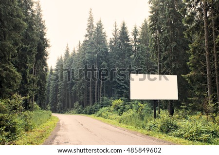 Blank billboard sign by empty highway through forest mountains landscape. Ad panel on road. Forest road with white billboard for your text. mock up