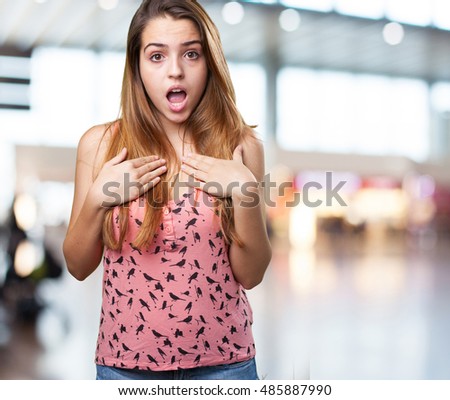 young pretty woman surprised on white background